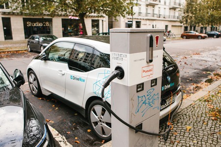 Berlin, October 2, 2017: The electric car is being charged at a special place for charging electric vehicles. A modern and eco-friendly mode of transport that has become widespread in Europe.のeditorial素材