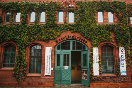 Berlin, October 1, 2017: Facade of the museum building is made of red brick with announcements about exhibitions and decorative grapesのeditorial素材