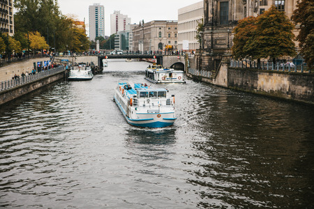 Berlin, October 1, 2017: Tourist boats cruise along the river Spree in Berlin, past sights and...