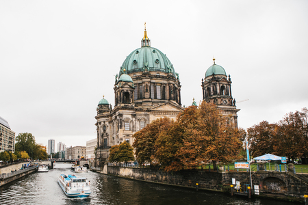 Berlin, October 1, 2017: Berlin Cathedral Berliner dom- beautiful old building with green dome next to the river Spree and tourist boatsのeditorial素材