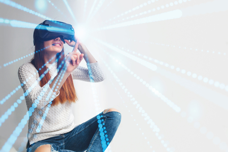 A young beautiful woman in glasses of virtual reality saw something amazing. Modern technologies. VRの写真素材