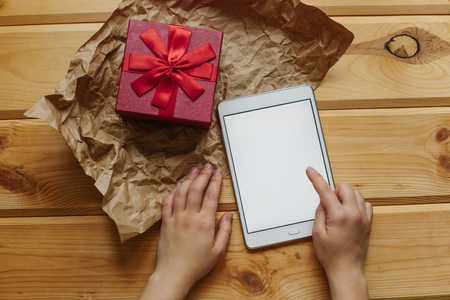 The girl received a gift and dials a message with words of gratitude.の写真素材