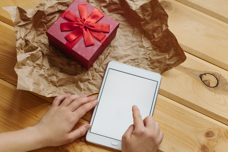 The girl received a gift and dials a message with words of gratitude.の写真素材