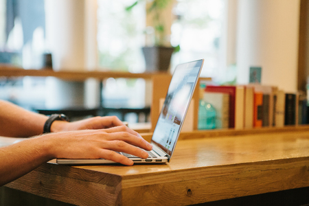 Freelancer or blogger works in a cafe on the computer. Work remotely.の写真素材