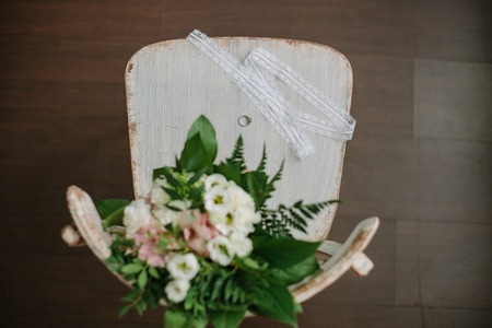 Wedding composition with flowers, ring and chair.の写真素材