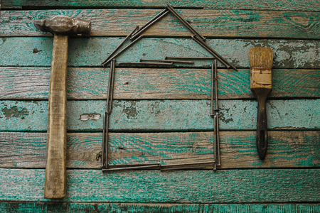 Hammer and nails on a wooden surface. Joinery tradition.の写真素材
