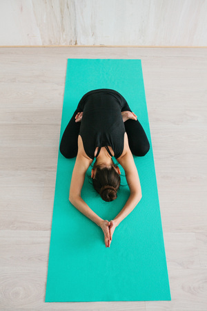 Young beautiful woman practicing yoga and gymnastic. Wellness concept. Classes in single sports.の写真素材