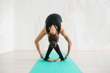 Young beautiful woman practicing yoga and gymnastic. Wellness concept. Classes in single sports.の写真素材