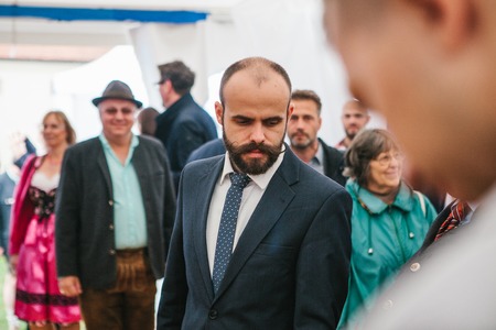 Prague, September 23, 2017: Celebration of the traditional German beer festival Oktoberfest in the Czech Republic. Unknown elegant man with unusual mustaches in a jacket with a tumbler at the event.のeditorial素材