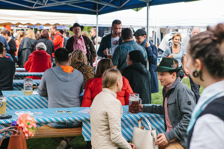 Prague, September 23, 2017: Celebrating the traditional German beer festival called Oktoberfest. Unknown men and women communicate and drink fresh German beer.のeditorial素材