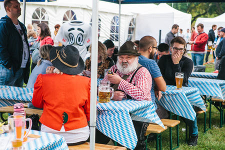 Prague, September 23, 2017: Celebrating the traditional German beer festival called Oktoberfest. People communicate with each other and drink fresh German beer.のeditorial素材