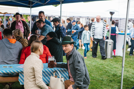 Prague, September 23, 2017: Celebrating the traditional German beer festival called Oktoberfest in the Czech Republic. Unknown men and women communicate and drink fresh German beer.のeditorial素材