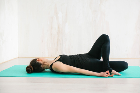 Young beautiful woman practicing yoga and gymnastic. Wellness concept. Classes in single sports.の写真素材