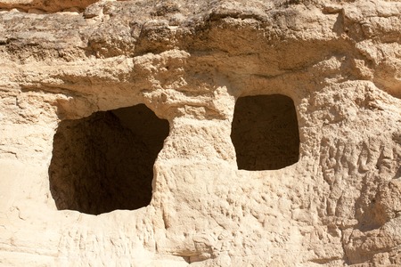 Holes in the mountains of Cappadocia in the form of windows. Inside the mountains is the habitation of ancient people who lived many millions of years ago. Now its empty.の写真素材