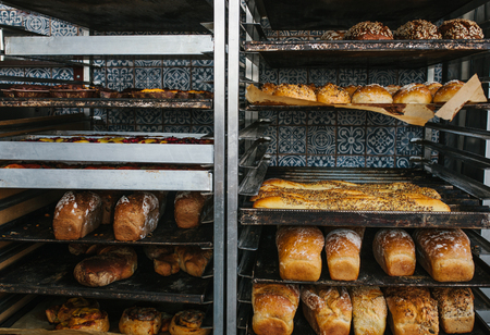 A lot of ready-made fresh bread in a bakery oven in a bakery. Bread making business.の写真素材