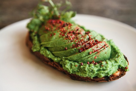 Sandwich with avocado on a plate. Delicious and healthy diet food.の写真素材