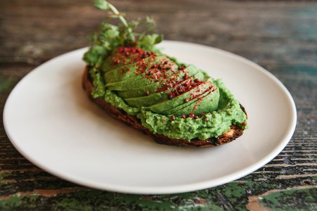 Sandwich with avocado on a plate. Delicious and healthy diet food.の写真素材