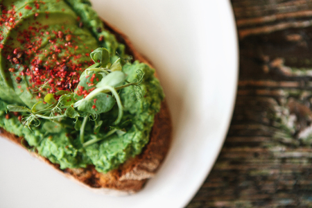 Top view. Sandwich with avocado on a plate. Delicious and healthy diet food.の写真素材
