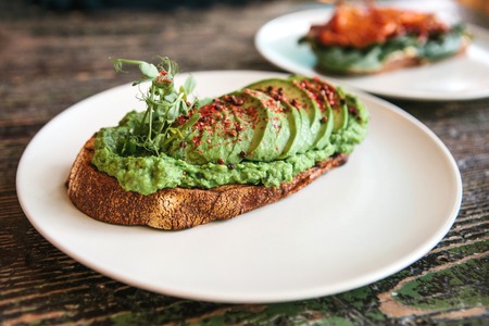 Sandwich with avocado on a plate. Delicious and healthy diet food.の写真素材