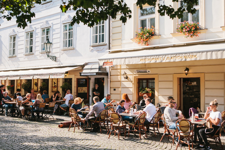 Prague, September 29, 2017: A popular street cafe near the Charles Bridge. Local residents and tourists rest, eat and communicate on a sunny warm day.のeditorial素材