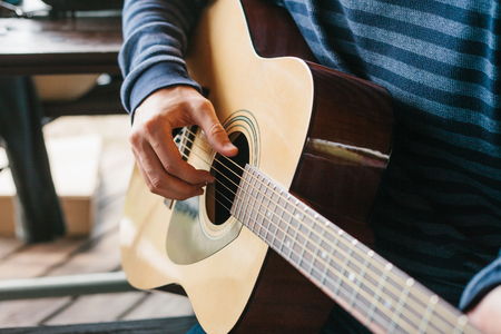 Learning to play the guitar. Music education.の写真素材
