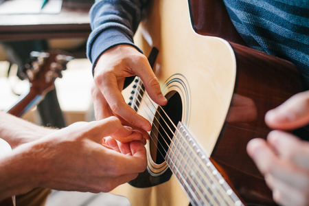 Learning to play the guitar. Music education.の写真素材