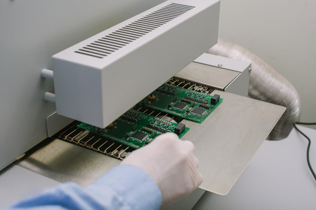 Computer expert professional technician examining board computer in a laboratory in a factory. Technical support.の写真素材