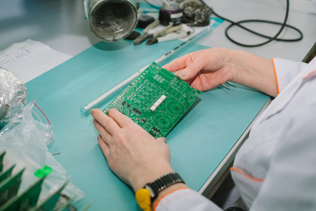 Computer expert professional technician examining board computer in a laboratory in a factory....