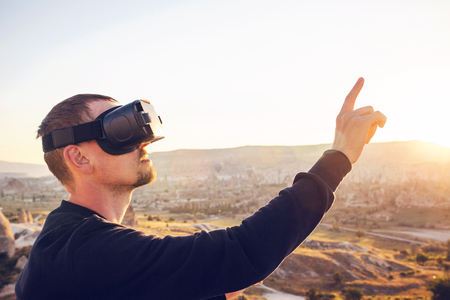 The man with glasses of virtual reality. Future technology concept. Modern imaging technology.の写真素材