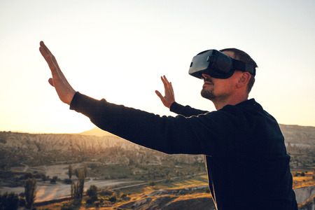 The man with glasses of virtual reality. Future technology concept. Modern imaging technology.の写真素材