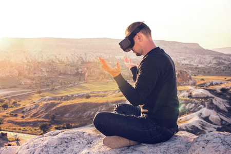 The man with glasses of virtual reality. Future technology concept. Modern imaging technology.の写真素材