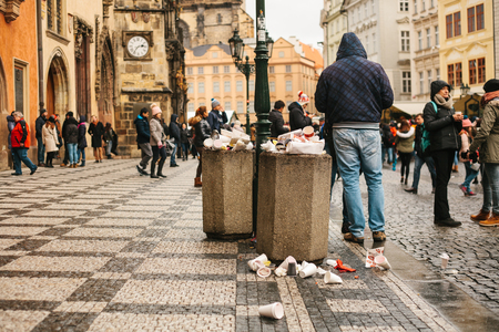 Prague, December 24, 2017: A crowded trash can on Pragues main square during the christmas holidays. A lot of people in the square. Pollution of city streets with trash on holidays.のeditorial素材