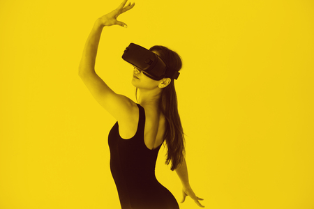 Young beautiful girl in glasses of a virtual reality. Use of modern technologiesの写真素材