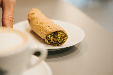 Italian sweet traditional food Cannoli. Fresh pastry with pistachio filling insideの写真素材