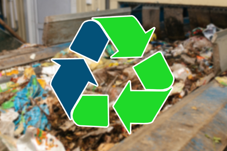 Sign recycling waste. The waste sorting and processing plant is blurry in the background