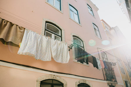 Authentic photography. Clothes dry on the facade of an apartment building in Lisbon in Portugal.の写真素材
