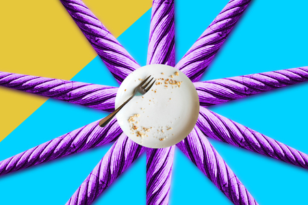 Minimal conceptual illustration of an empty plate with crumbs on an abstract colored background in the form of the sunの写真素材