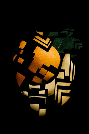 Creative mix of orange and banana in a minimalistic abstract mosaic style on a black background. My design, idea and art work.の写真素材