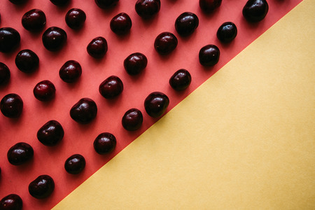 A lot of ripe cherries on a colored backgroundの写真素材