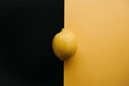Fresh juicy lemon on a yellow black backgroundの写真素材