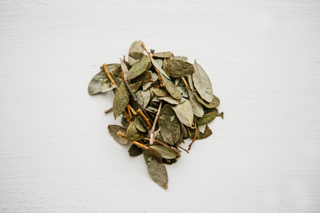 Dry grass blueberries for cooking useful tea herbal lies on a wooden surface.の写真素材
