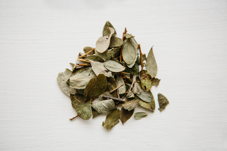 Dry grass blueberries for cooking useful tea herbal lies on a wooden surface.の写真素材