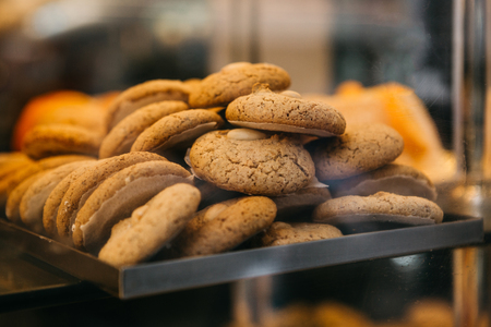 Many freshly baked delicious cookies are on the counter in the bakery.の写真素材