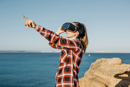 The girl in glasses of a virtual reality. Modern technology in everyday life.