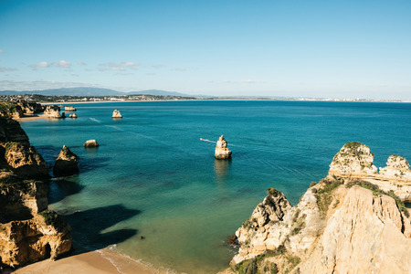 Beautiful views of the Atlantic Ocean and the rocks off the coast of Portugal next to the city called Lagos. Amazing natural landscape.の写真素材