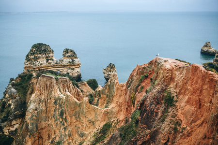 Beautiful views of the Atlantic Ocean and the rocks off the coast of Portugal next to the city called Lagos. Amazing natural landscape.の写真素材