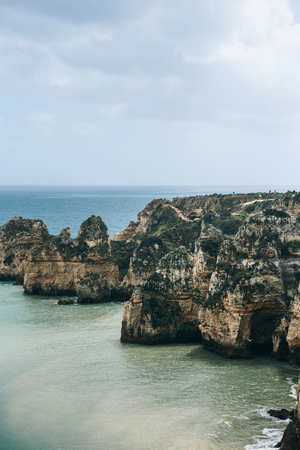 Beautiful views of the Atlantic Ocean and the rocks off the coast of Portugal next to the city called Lagos. Amazing natural landscape.の写真素材