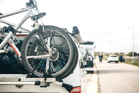 Portugal, Lagos, April 12, 2018: Close-up. A car for traveling with bicycles is parked at the side of the road. Active rest and family travel.のeditorial素材
