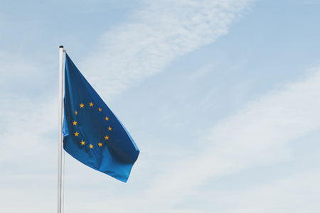 Flag of the European Union on the flagpole against the sky.の写真素材