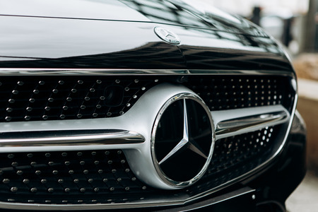 Berlin, August 29, 2018: A close-up of the Mercedes Benz sign on the new black Mercedes-Benz SLC. The inscription in German is translated as young stars.のeditorial素材